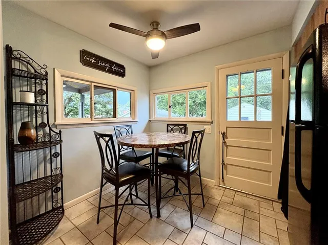 a view of a dining room with furniture a chandelier and wooden floor
