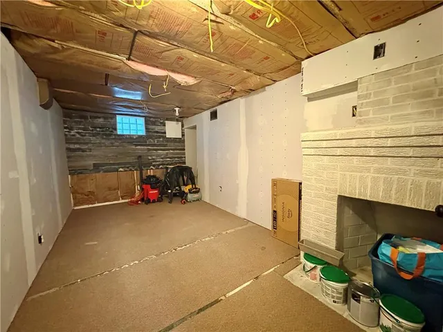 a view of a garage with furniture and fireplace