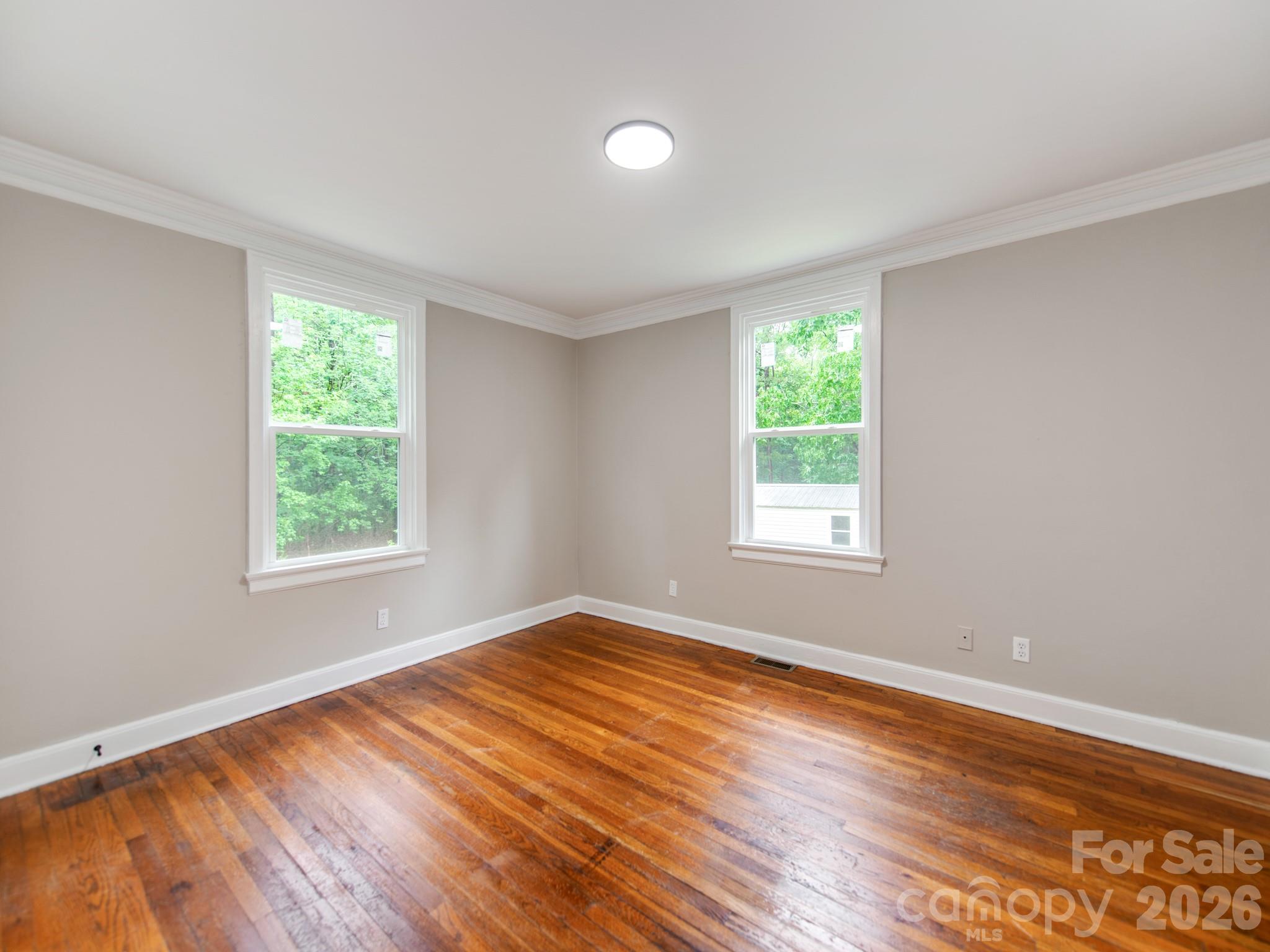 4699 Cherrystone Road Lancaster, SC 29720 - Photo 15 of 28 a view of an empty room with wooden floor and a window
