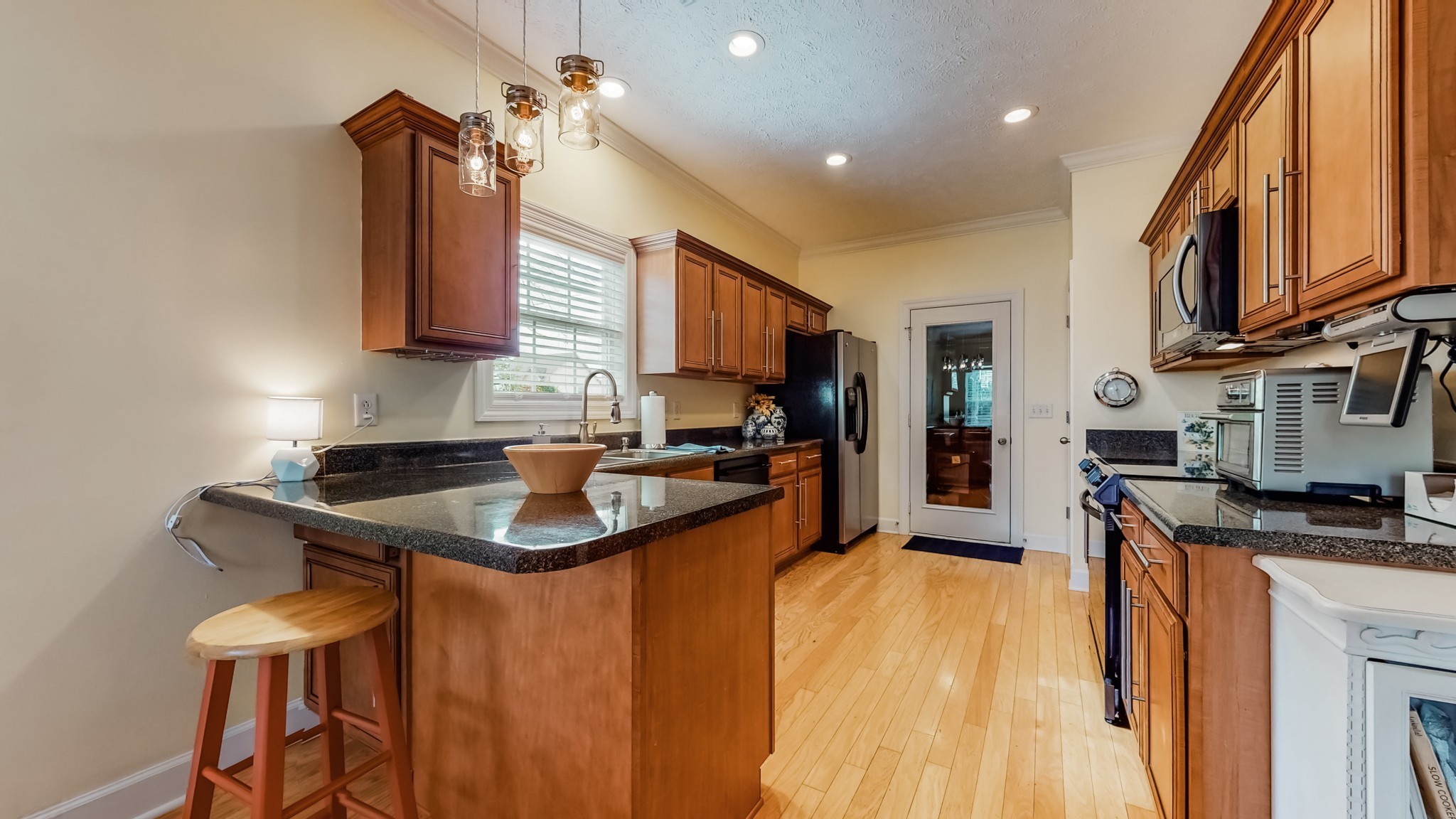 1815 Potters Court Murfreesboro, TN 37128 - Photo 16 of 49 a kitchen with stainless steel appliances granite countertop a sink a stove and a refrigerator