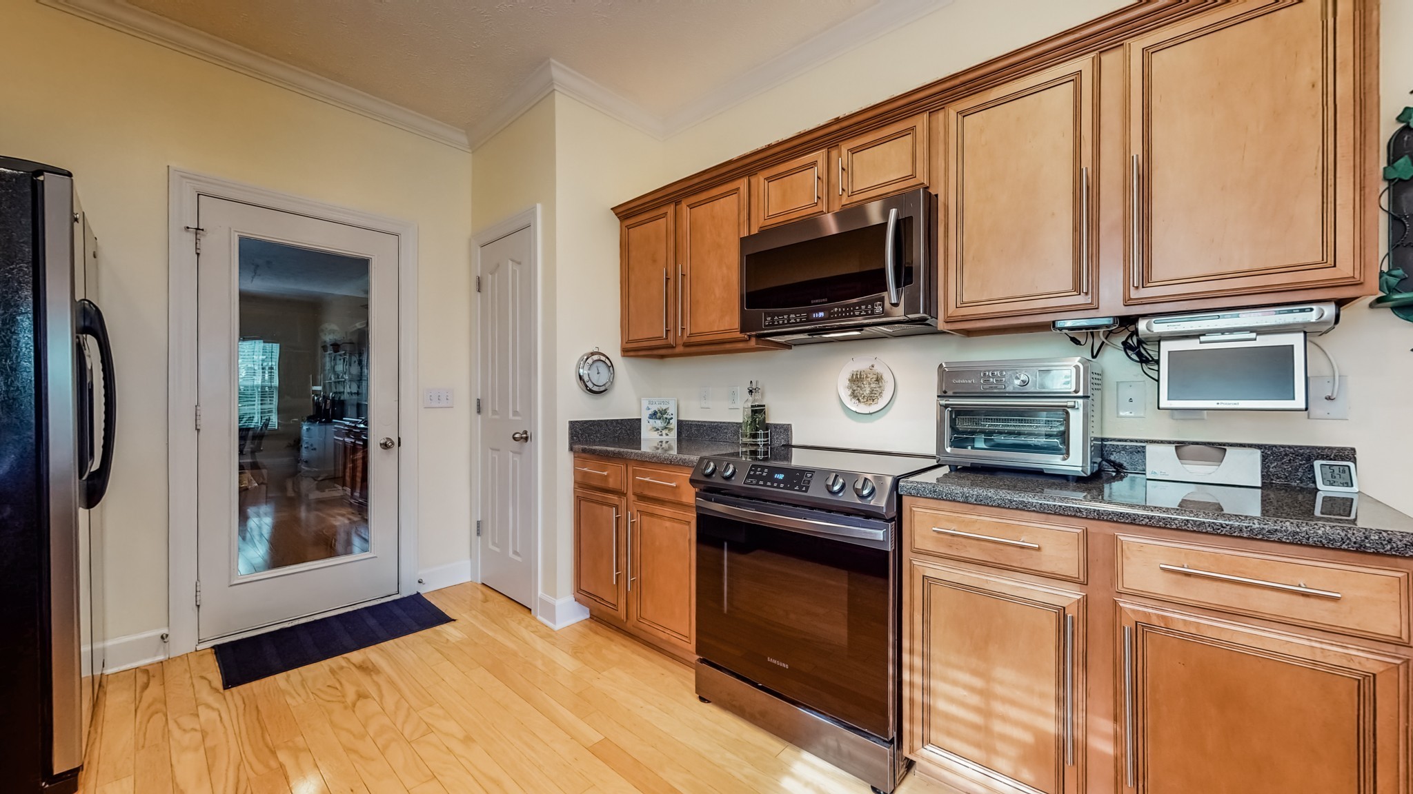1815 Potters Court Murfreesboro, TN 37128 - Photo 18 of 49 a kitchen with stainless steel appliances granite countertop a stove microwave and sink