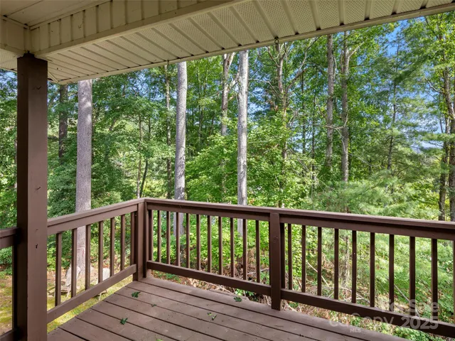 a view of a wooden deck next to a yard