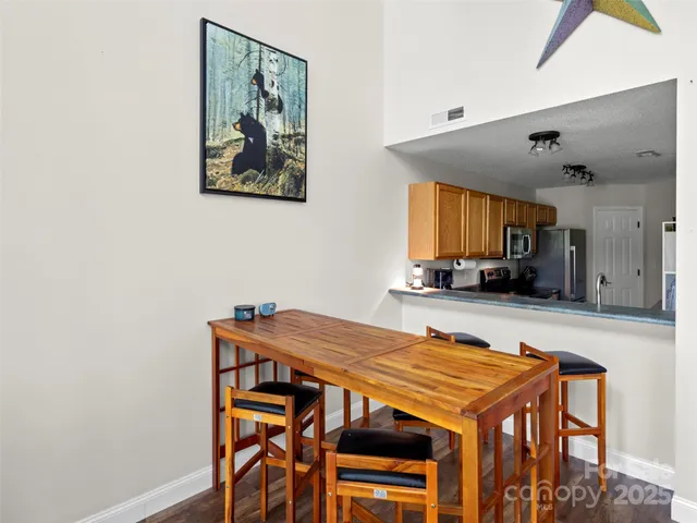 a view of a dining room with furniture and a large window