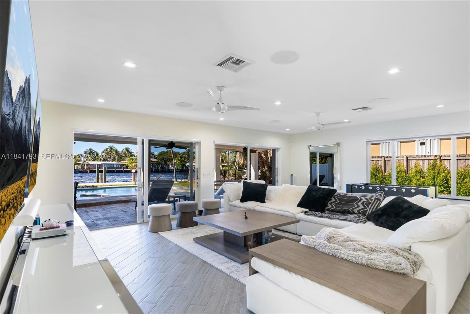 517 South Riverside Drive Pompano Beach, FL 33062 - Photo 12 of 21 a living room with furniture fireplace and large windows