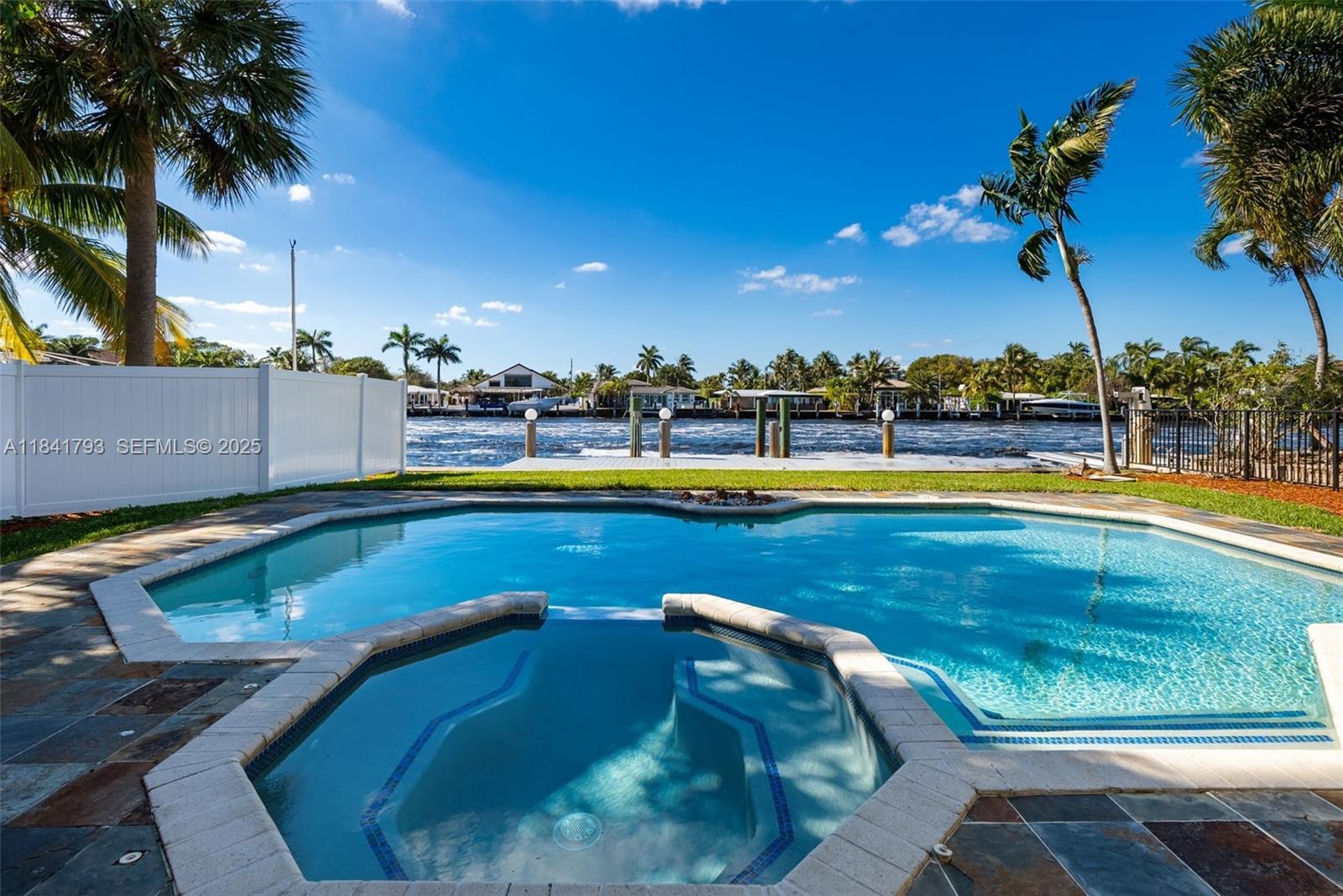517 South Riverside Drive Pompano Beach, FL 33062 - Photo 13 of 21 a view of a swimming pool and lounge chairs