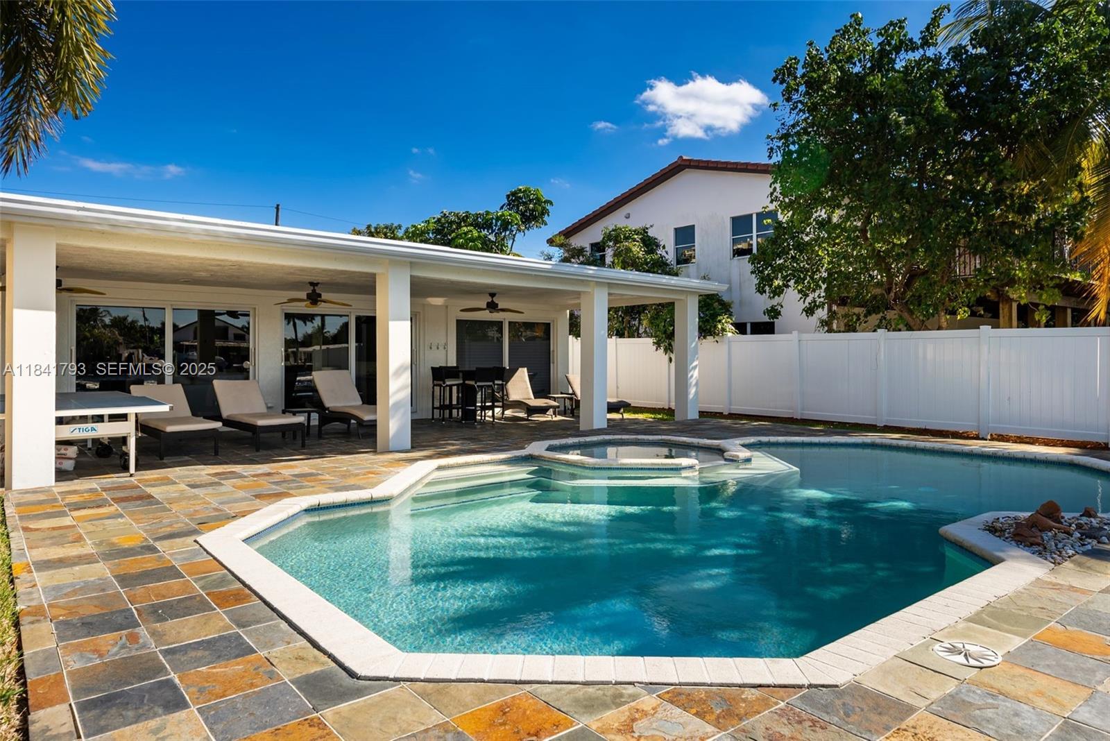 517 South Riverside Drive Pompano Beach, FL 33062 - Photo 16 of 21 a view of a house with swimming pool patio and a garden