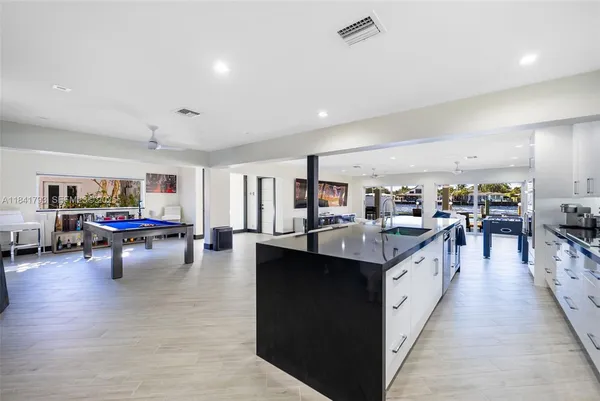 a living room with lots of furniture and kitchen