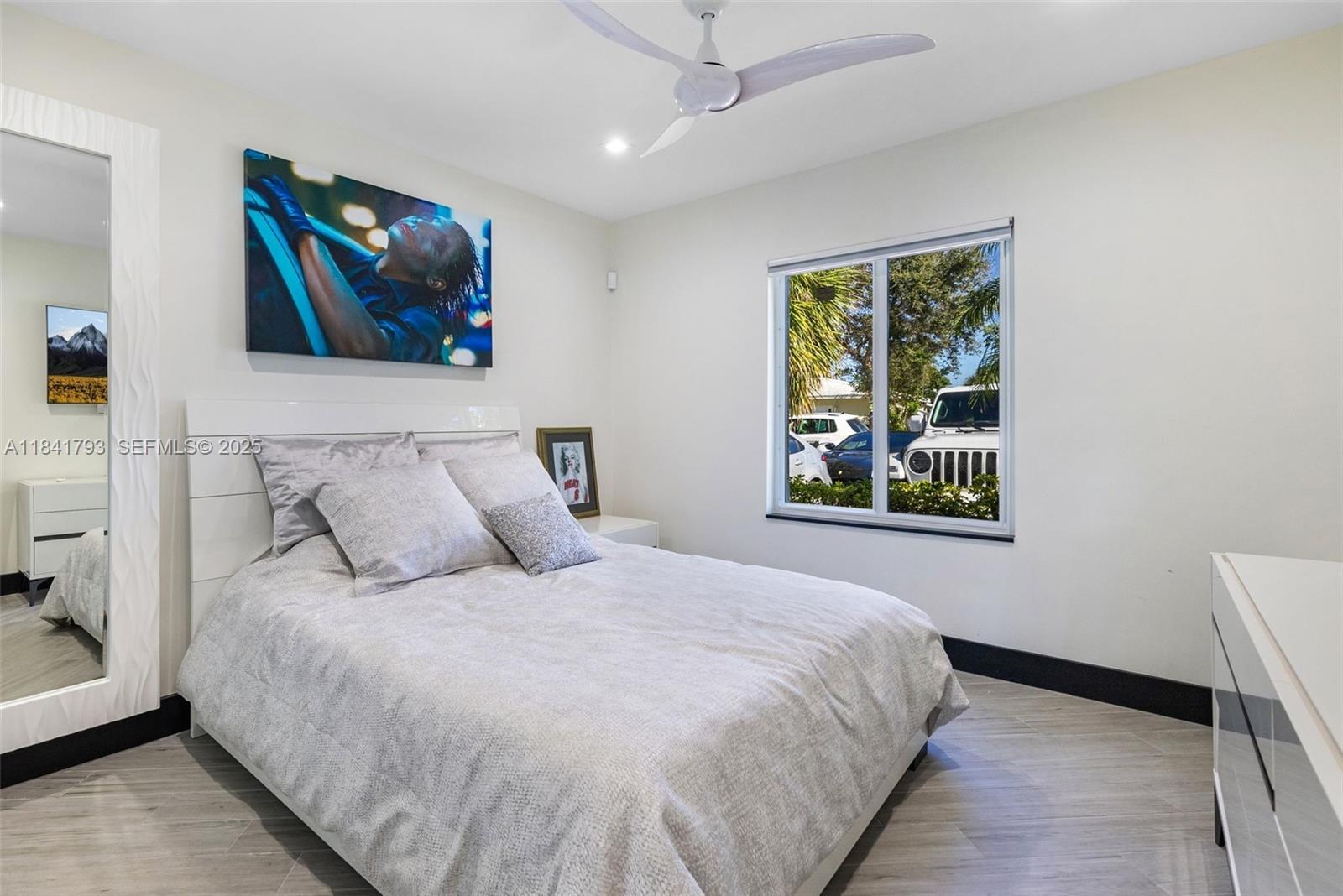 517 South Riverside Drive Pompano Beach, FL 33062 - Photo 4 of 21 a bedroom with a large bed and a window