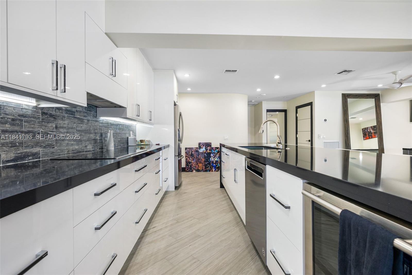 517 South Riverside Drive Pompano Beach, FL 33062 - Photo 6 of 21 a large white kitchen with stainless steel appliances