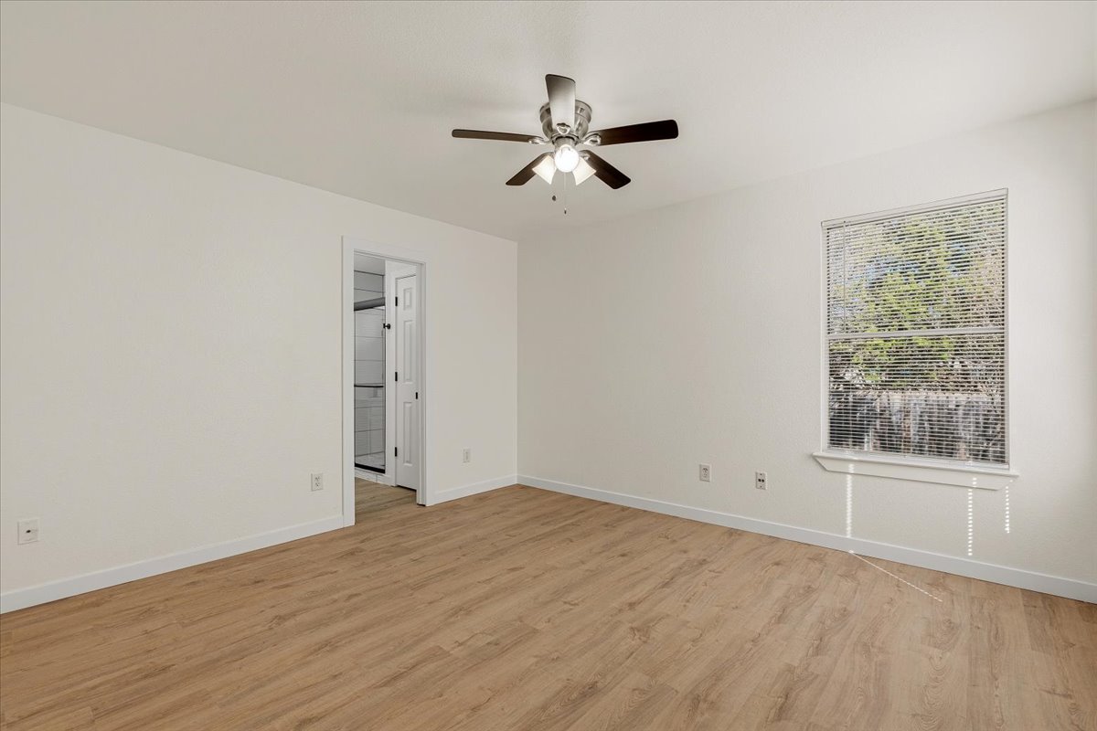 1007 Port Daniel Drive Leander, TX 78641 - Photo 11 of 21 Empty room with light wood finished floors and a ceiling fan