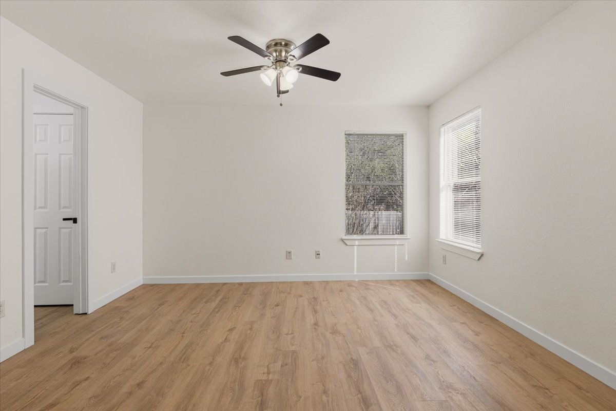 1007 Port Daniel Drive Leander, TX 78641 - Photo 10 of 21 Unfurnished room with light wood-style floors and ceiling fan
