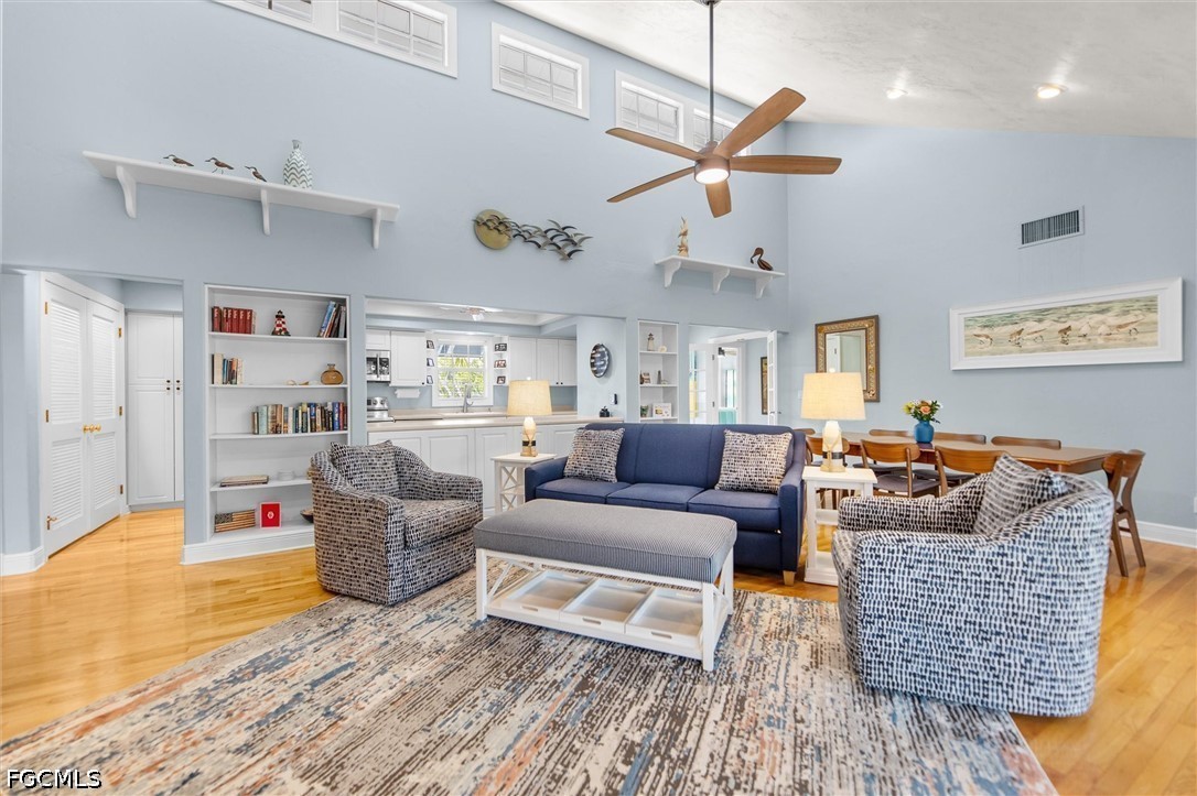 5304 Ladyfinger Lake Road Sanibel, FL 33957 - Photo 13 of 48 a living room with furniture or kitchen view and a wooden floor
