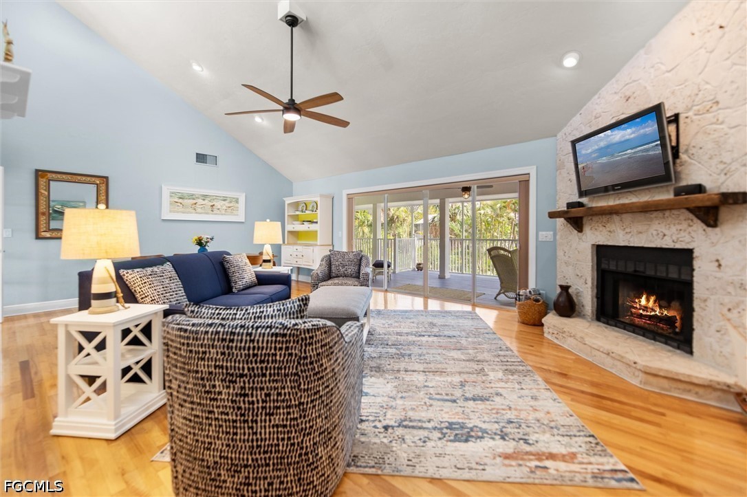 5304 Ladyfinger Lake Road Sanibel, FL 33957 - Photo 14 of 48 a living room with furniture a flat screen tv and a fireplace