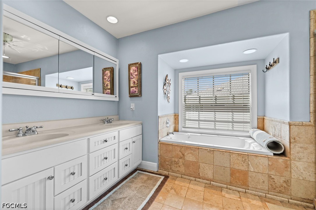 5304 Ladyfinger Lake Road Sanibel, FL 33957 - Photo 18 of 48 a bathroom with a tub sink and mirror