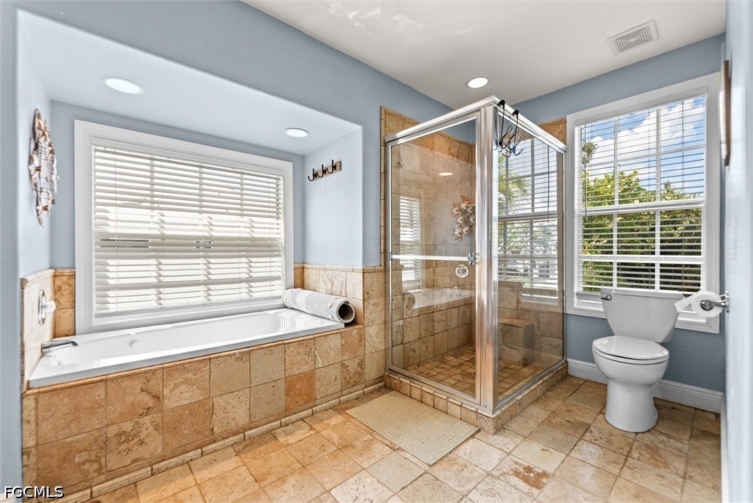 5304 Ladyfinger Lake Road Sanibel, FL 33957 - Photo 19 of 48 a spacious bathroom with a tub mirror and window