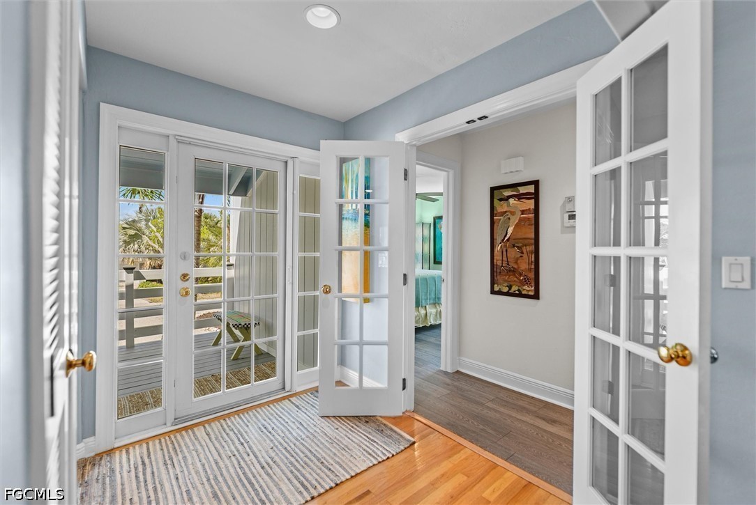 5304 Ladyfinger Lake Road Sanibel, FL 33957 - Photo 21 of 48 a view of a bedroom with wooden floor and front door
