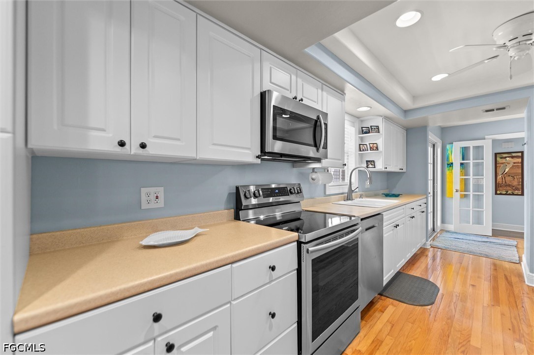 5304 Ladyfinger Lake Road Sanibel, FL 33957 - Photo 10 of 48 a kitchen with stainless steel appliances granite countertop a stove a sink and a microwave