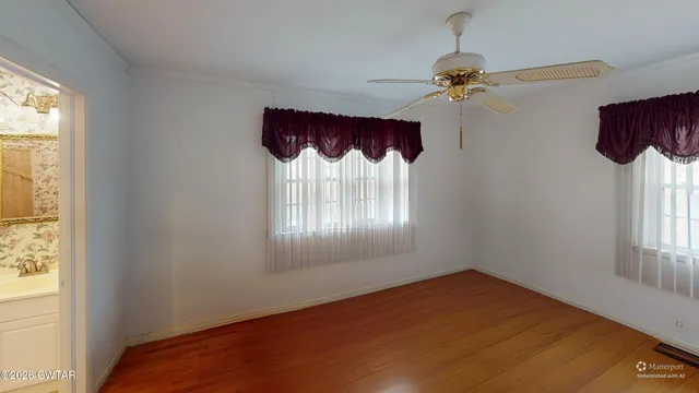 a view of a bedroom with a window and a chandelier fan