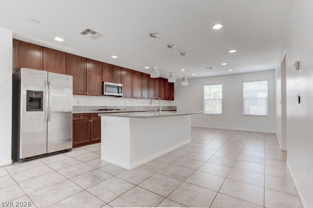 4650 Ranch House Road, Unit 47 North Las Vegas, NV 89031 - Photo 7 of 43 A contemporary kitchen features rich cabinetry, gleaming countertops, and an inviting island for culinary pursuits.