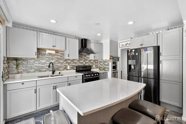 a kitchen with stainless steel appliances a refrigerator sink and cabinets