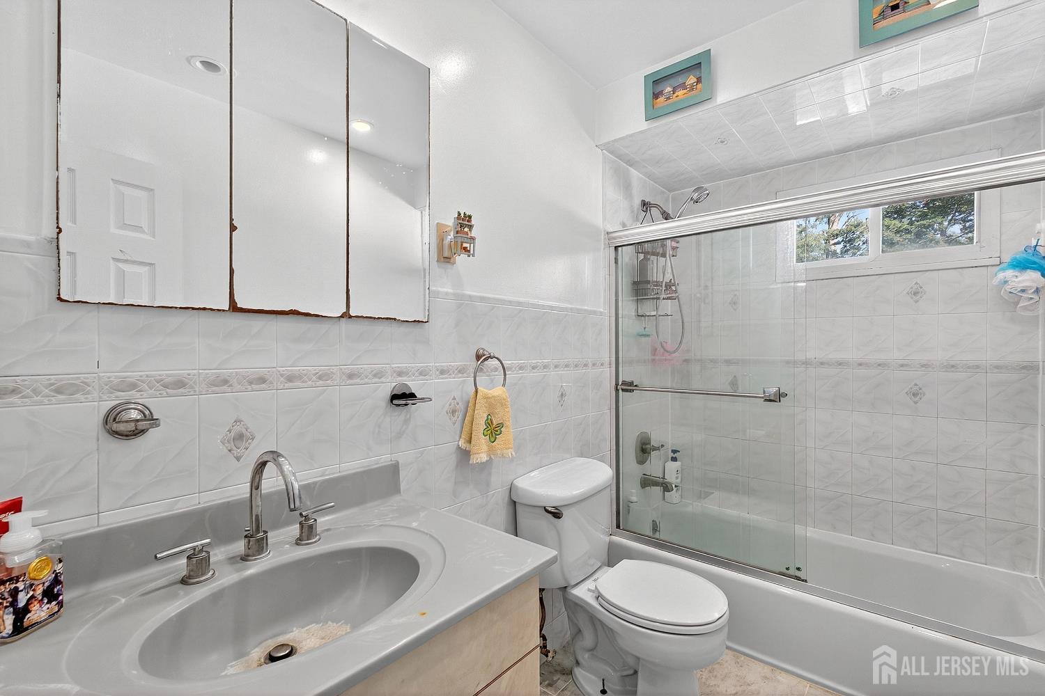 124 Cindy Court Middlesex, NJ 08846 - Photo 14 of 27 a bathroom with a sink a toilet and shower