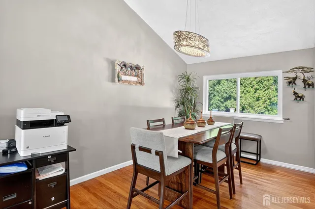 a view of a dining room with furniture and a window