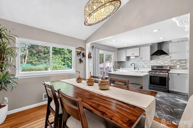 a kitchen with a table chairs stove and cabinets