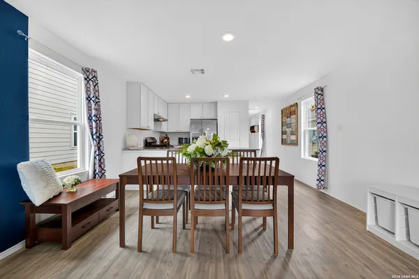 a view of a dining room with furniture and wooden floor