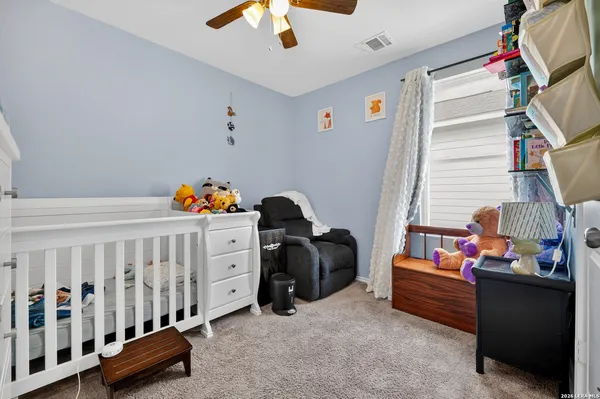 a bedroom with furniture and a baby crib