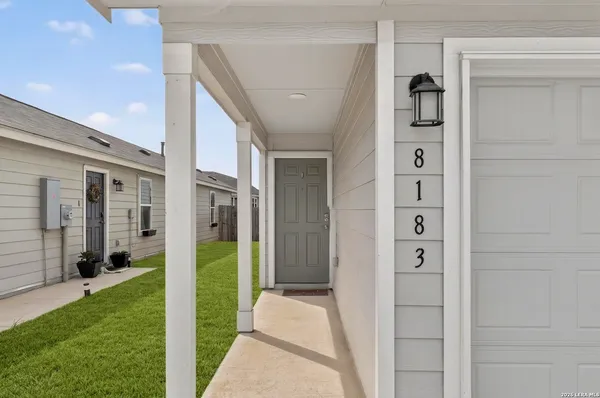 a view of a porch with a door and wooden floor