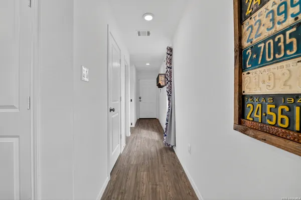 a view of hallway with wooden floor
