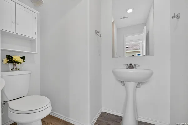 a bathroom with a sink toilet and a mirror