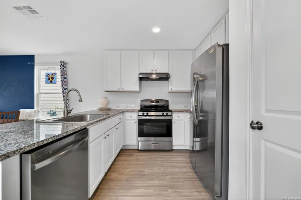 a kitchen with a sink stove and refrigerator