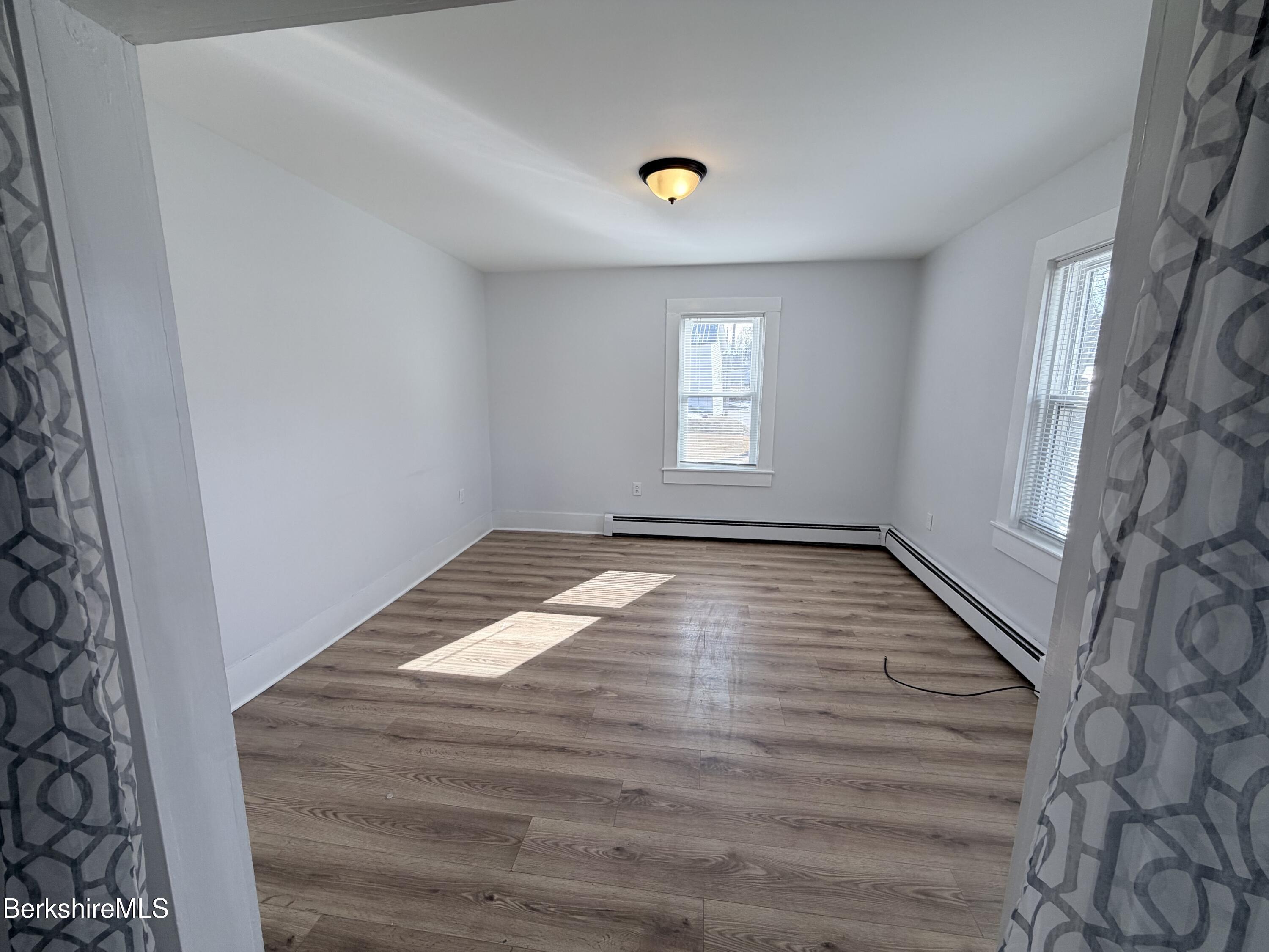 50 Temple Street Adams, MA 01220 - Photo 4 of 14 a view of empty room with window and wooden floor