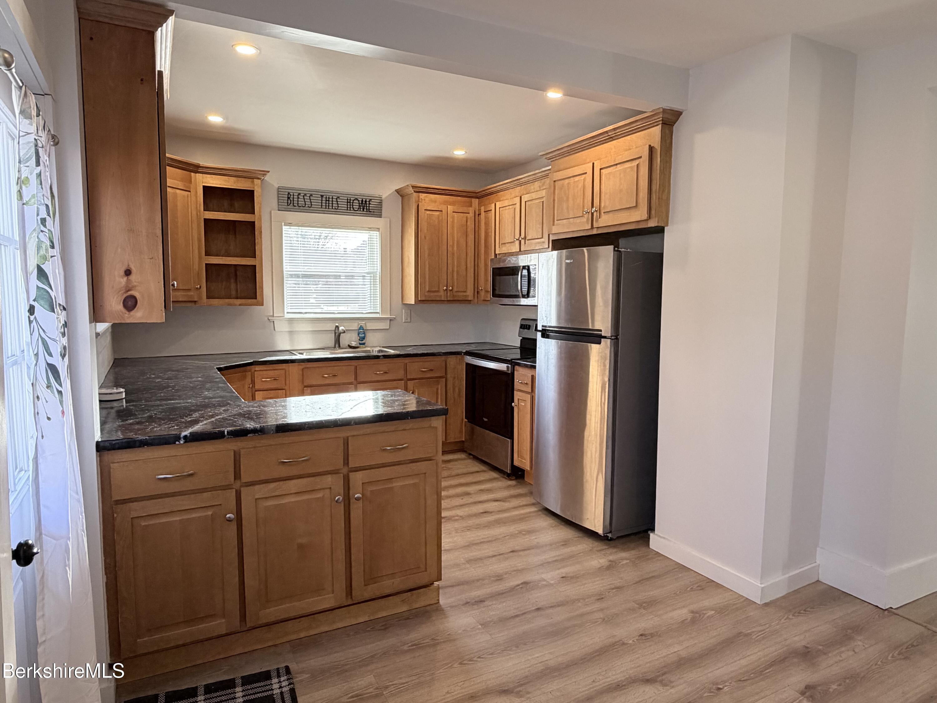 50 Temple Street Adams, MA 01220 - Photo 9 of 14 a kitchen with stainless steel appliances granite countertop a refrigerator a sink a stove and oven