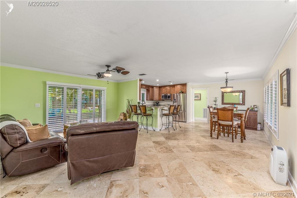 4780 Southeast Glen Ridge Trail Stuart, FL 34997 - Photo 12 of 31 a living room with furniture and a large window