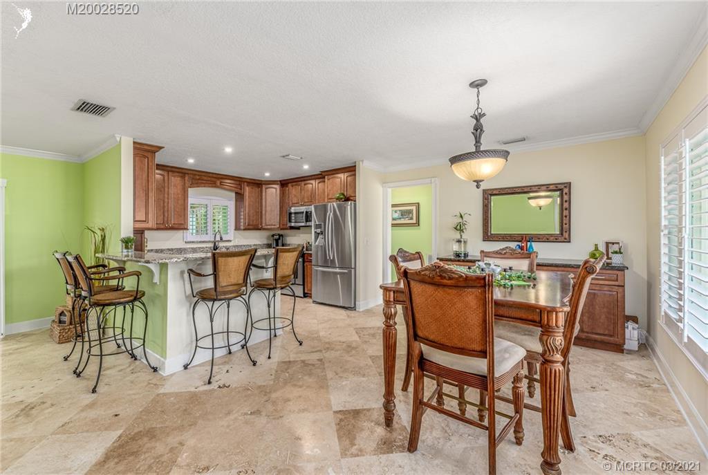 4780 Southeast Glen Ridge Trail Stuart, FL 34997 - Photo 15 of 31 a view of a dining room with furniture
