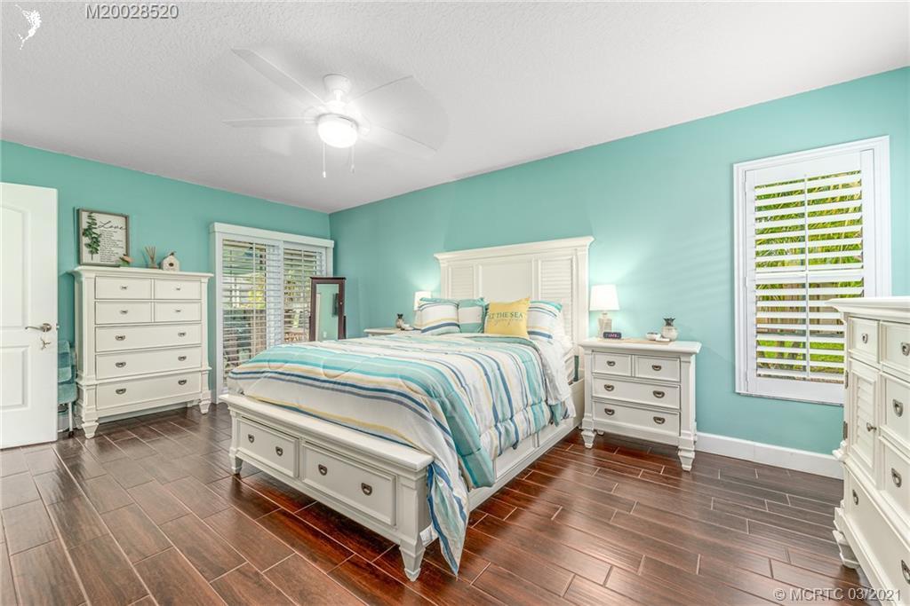 4780 Southeast Glen Ridge Trail Stuart, FL 34997 - Photo 20 of 31 a bedroom with a bed and a television