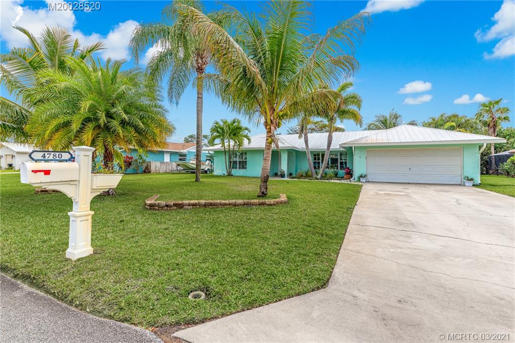 4780 Southeast Glen Ridge Trail Stuart, FL 34997 - Photo 2 of 31 a view of a yard with palm trees