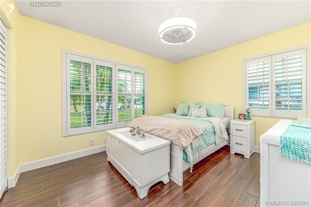 4780 Southeast Glen Ridge Trail Stuart, FL 34997 - Photo 23 of 31 a spacious bedroom with a bed and a large window