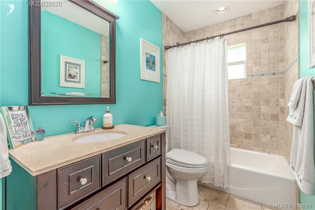 4780 Southeast Glen Ridge Trail Stuart, FL 34997 - Photo 25 of 31 a bathroom with a sink a toilet and a bathtub