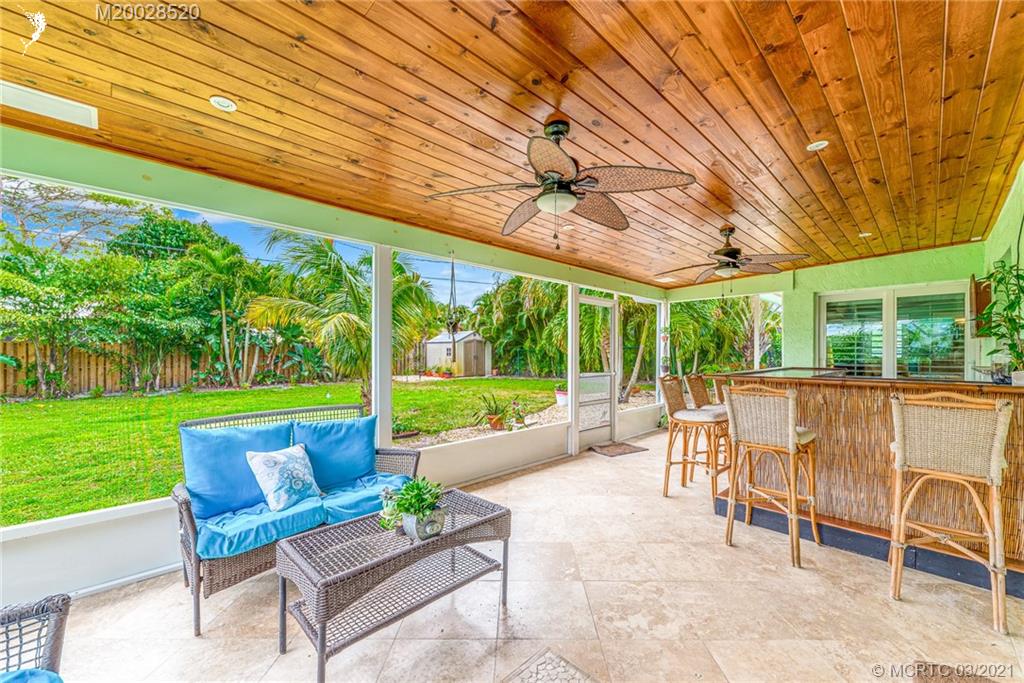 4780 Southeast Glen Ridge Trail Stuart, FL 34997 - Photo 26 of 31 a view of a patio with a table chairs and a backyard