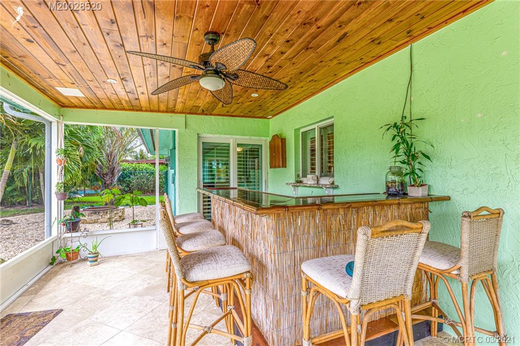 4780 Southeast Glen Ridge Trail Stuart, FL 34997 - Photo 27 of 31 a view of a patio with table and chairs and potted plants
