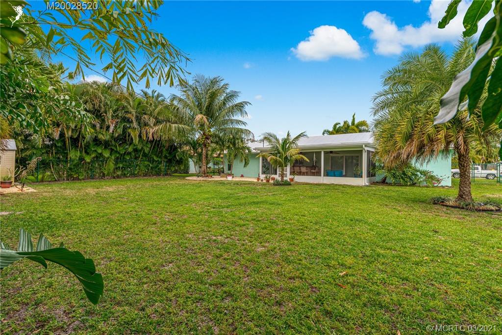 4780 Southeast Glen Ridge Trail Stuart, FL 34997 - Photo 29 of 31 a front view of a house with yard and green space