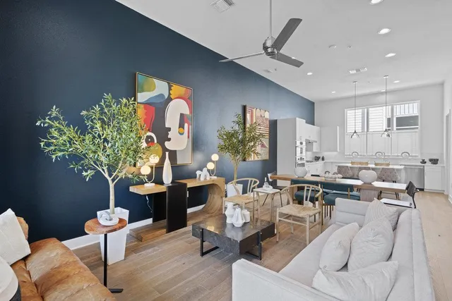 a living room with furniture potted plant and a large window