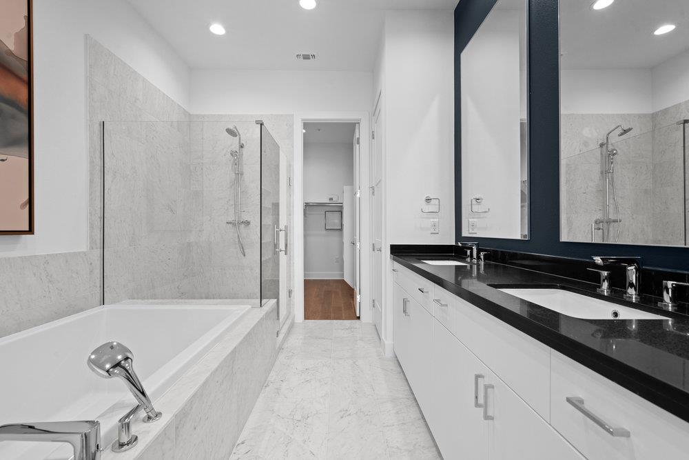 2805 McCurdy Street, Unit 4 Austin, TX 78723 - Photo 18 of 40 a spacious bathroom with a tub sink and mirror