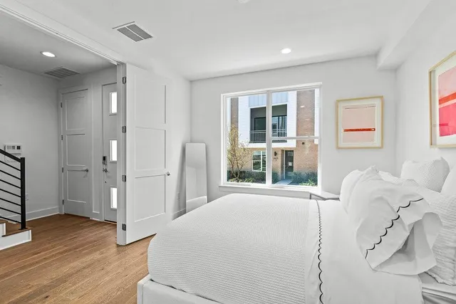 a bedroom with a bed and a window