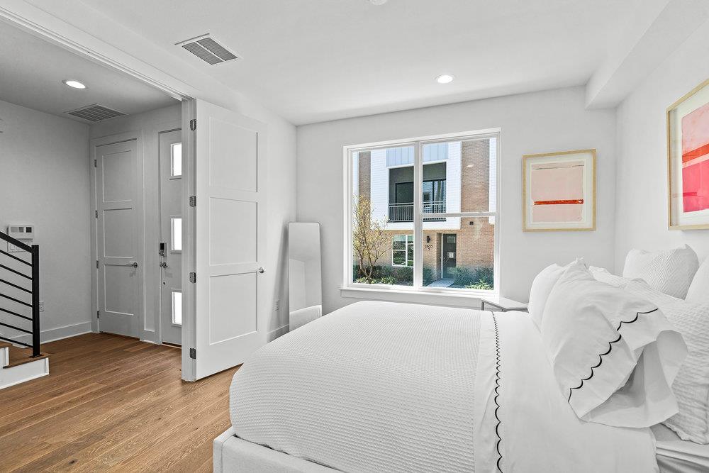 2805 McCurdy Street, Unit 4 Austin, TX 78723 - Photo 22 of 40 a spacious bedroom with a large bed and wooden floor