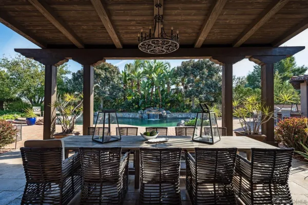 a view of a patio with a table chairs and a wooden floor