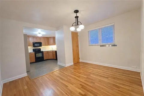 a view of a kitchen with a sink and dishwasher kitchen view with wooden floor